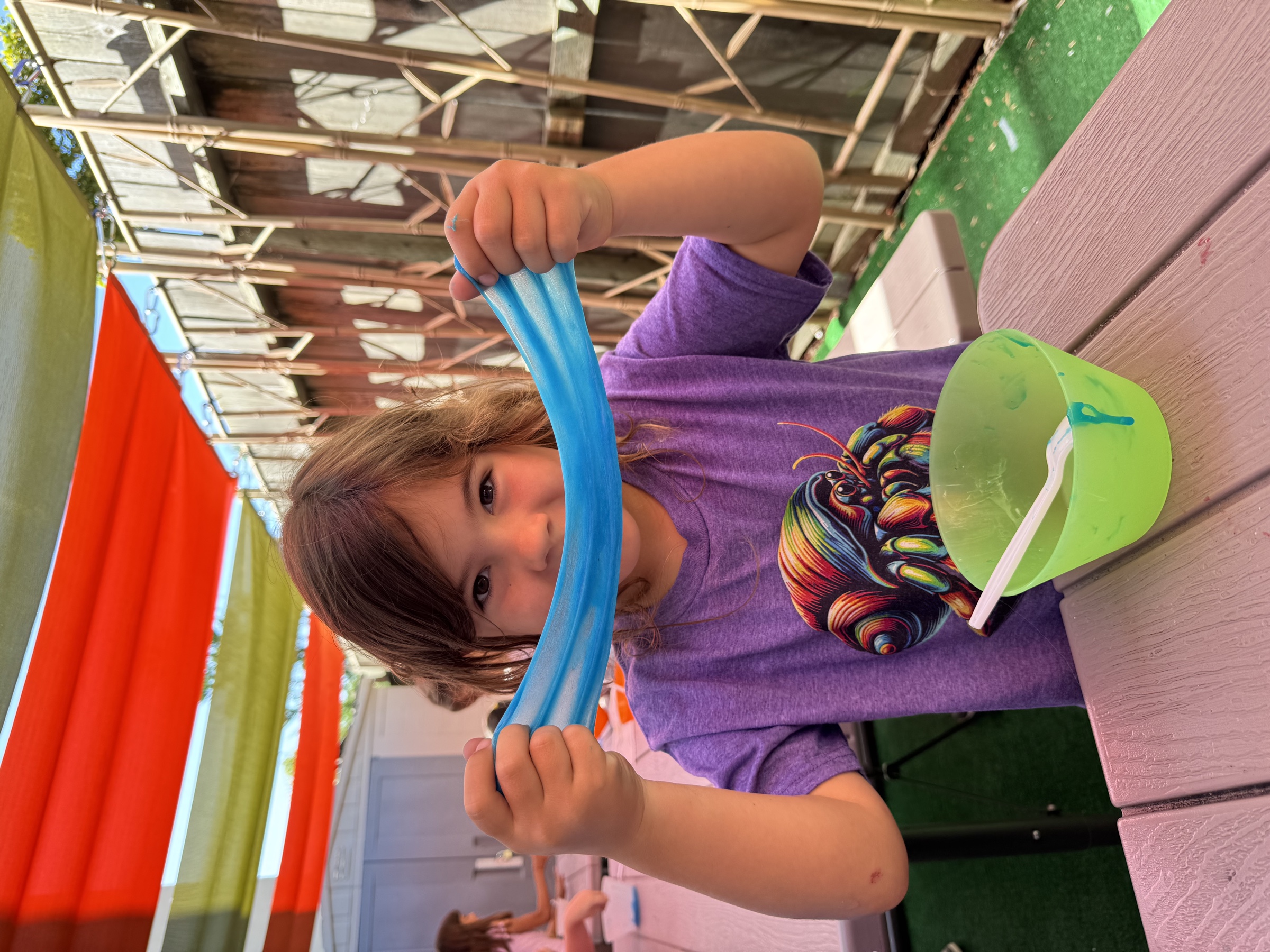 A camper stretching blue slime at Safari Run summer camp